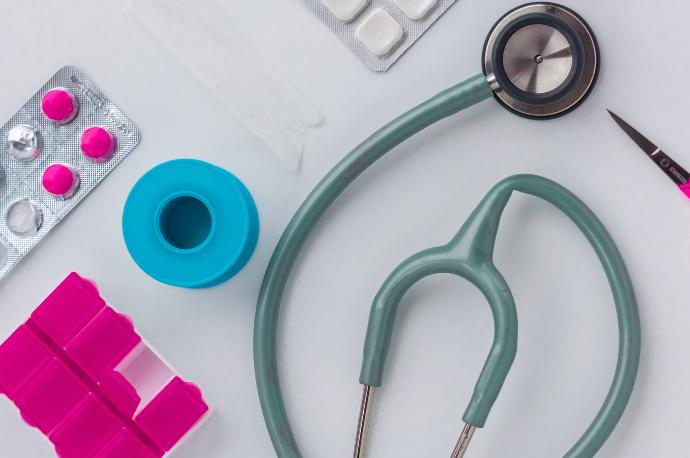 green and silver stethoscope on white envelope